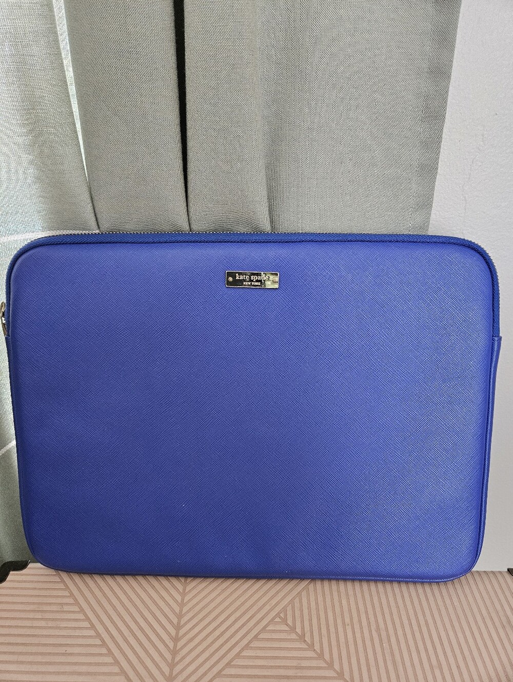 kate spade cobalt blue laptop sleeve with gold logo plaque